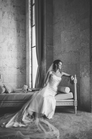 A series of black and white photos showing a figure in a flowing white dress moving gracefully through a minimalist space.