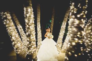 Wedding reception venue illuminated with hanging twinkle lights creating magical atmosphere.