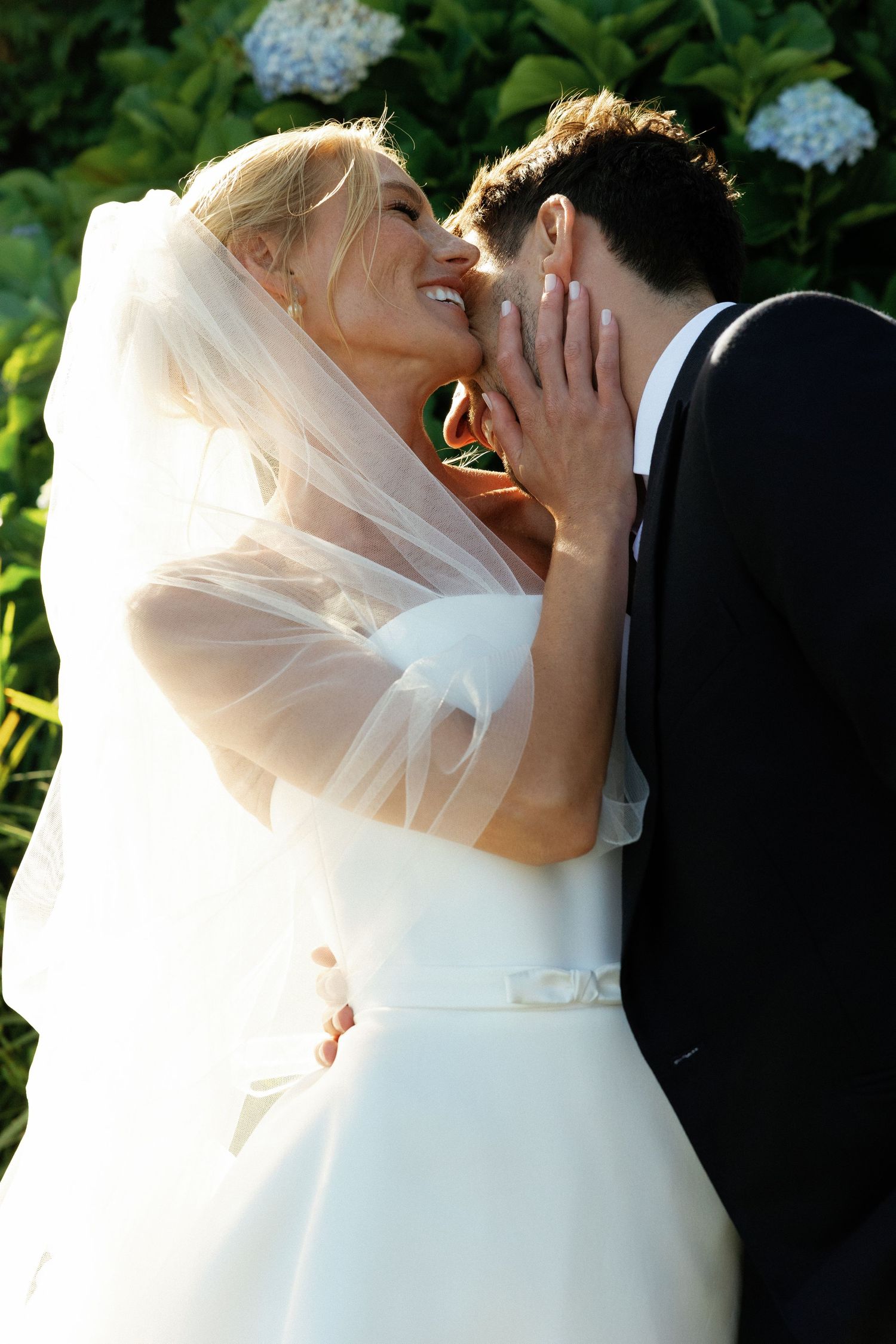 A sequence of romantic outdoor wedding photos showing joyful moments between newlyweds among garden flowers.