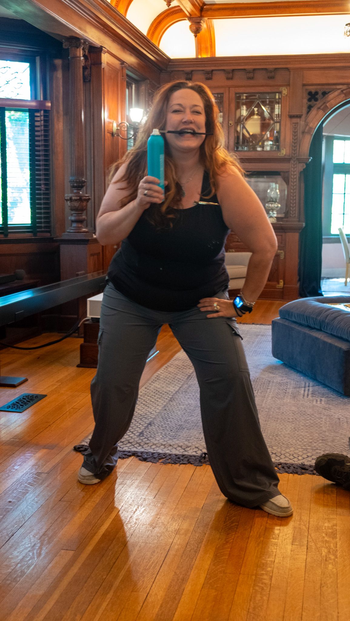 A sequence of exercise movements showing proper form for lunges on a hardwood floor in a room with wooden furniture.