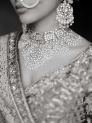 Elegant pearl and crystal necklace adorns a formal bridal look in a black and white portrait series.