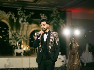 A wedding reception venue decorated with elegant lighting and floral arrangements during an evening celebration.
