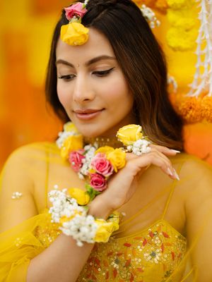 A dreamy portrait series with yellow roses and delicate baby's breath flowers against a warm golden bokeh background.