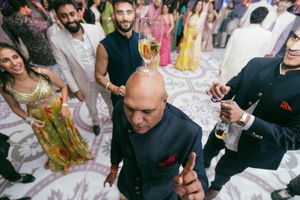 People enjoying drinks and socializing at a lively party gathering with colorful decor and beverages.