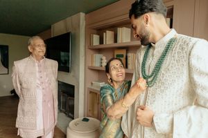 A sequence of photos showing a person helping an elderly individual get dressed in a pink shirt.