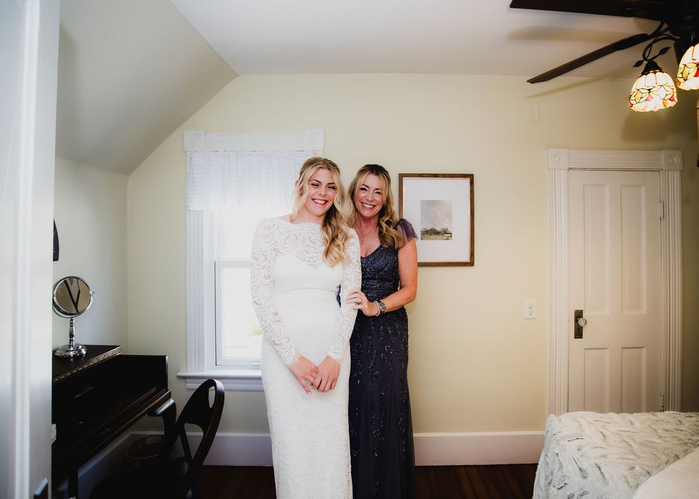 Candid moments captured in a bright, modern bedroom during wedding preparations.