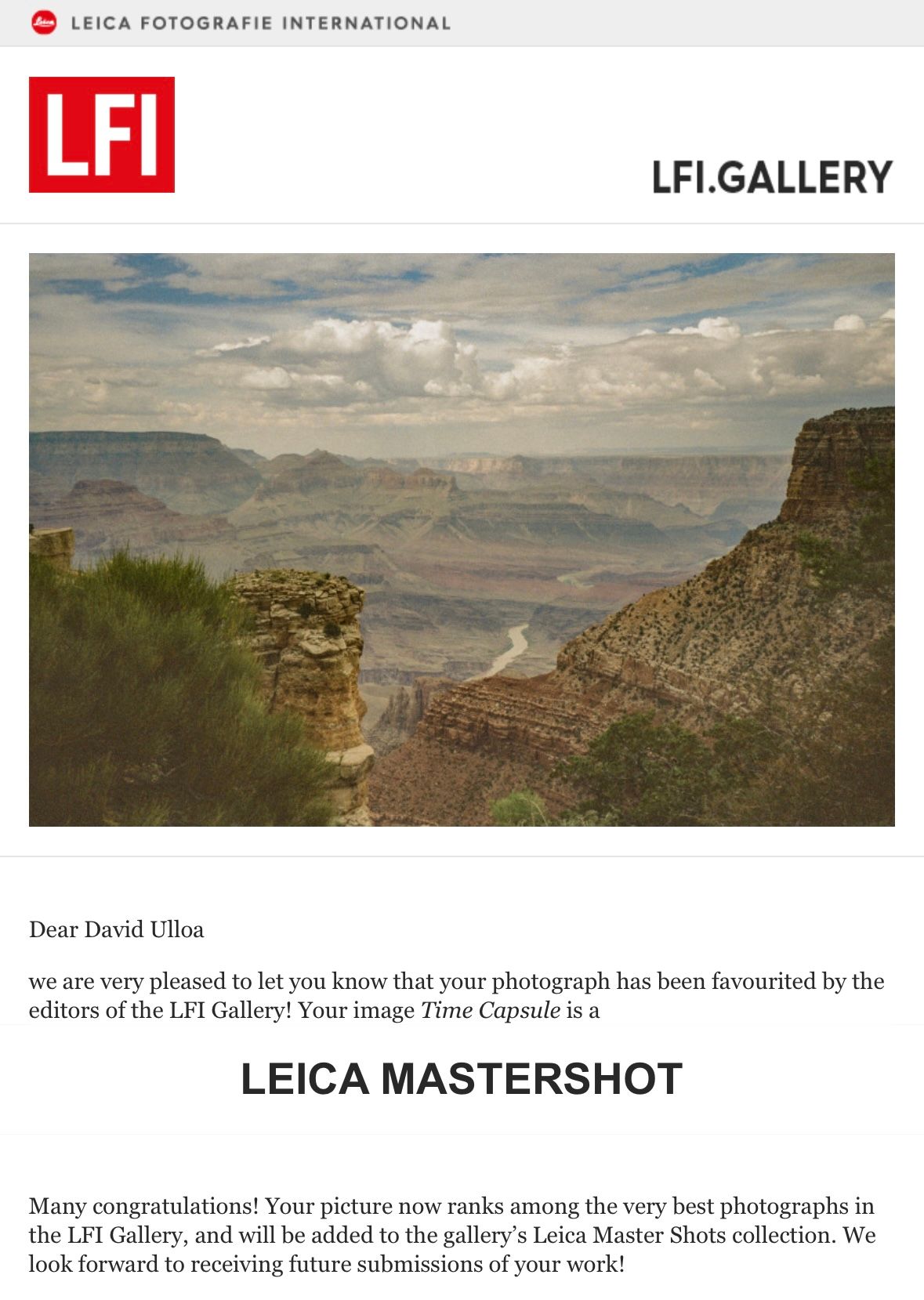 Dramatic view of the Grand Canyon's layered cliffs and distant plateaus under cloudy skies.