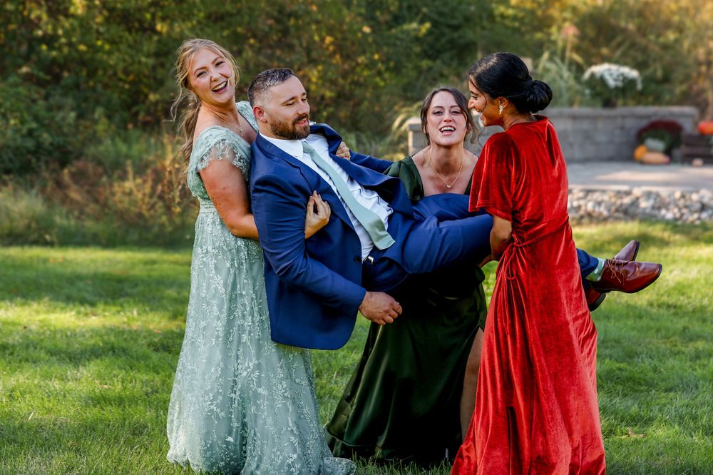 Wedding party having fun with playful poses outdoors on a sunny day.