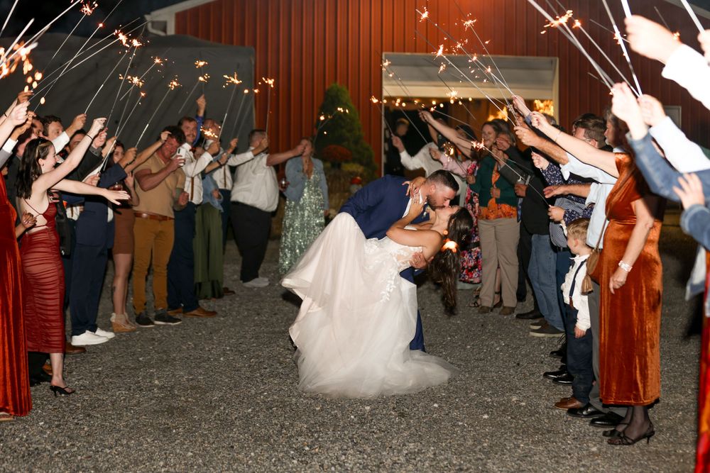 Sparkler exit with guests creating a glowing tunnel for the couple's grand departure.