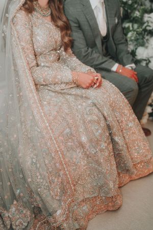 A detailed shot of a sparkly wedding gown with intricate embroidery and beadwork.
