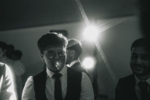 Artistic black and white photo of guests at an evening wedding reception.