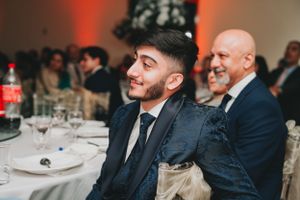 Two guests enjoying a formal dinner reception with smiles and laughter.