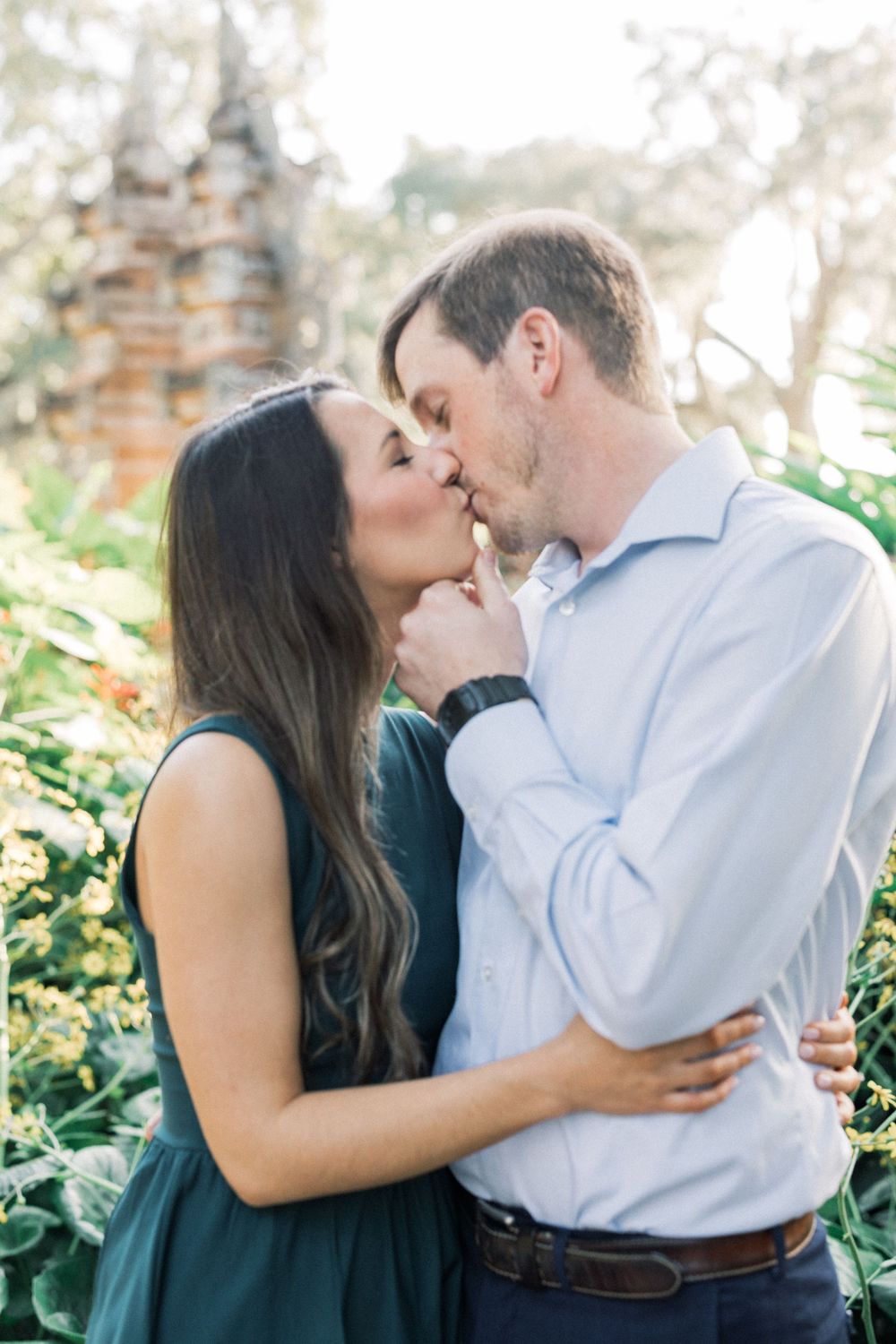 Romantic couple sharing tender moment in garden setting.