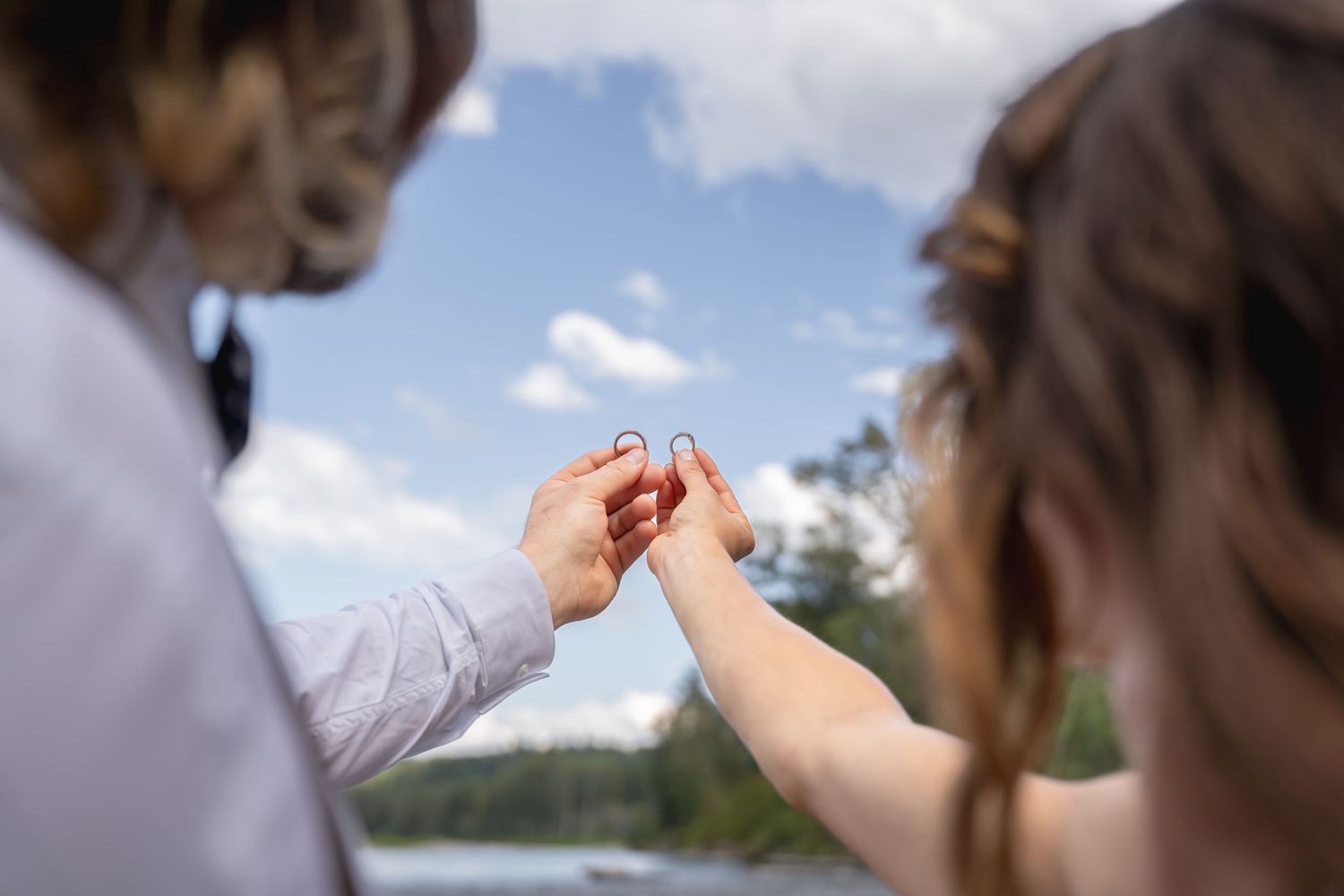 Intimate wedding kiss captured in soft natural lighting outdoors.