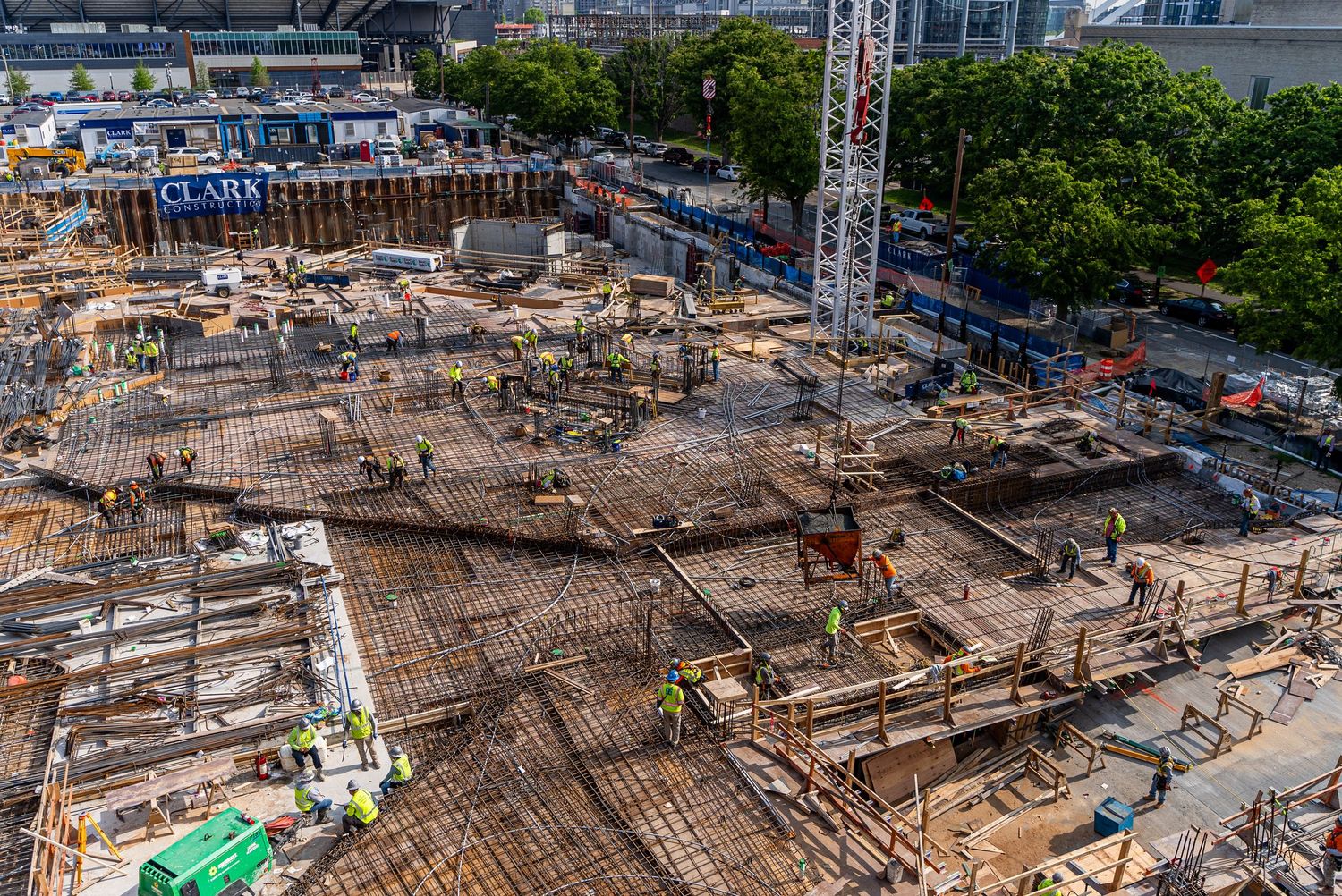Bird's eye view of construction site showing concrete formwork and rebar installation.