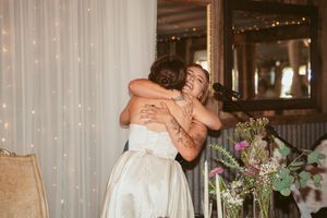 A wedding reception sequence showing multiple couples embracing and dancing in an elegant venue with white drapes and floral decor.
