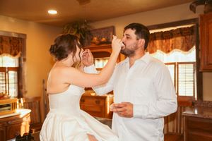 Intimate dance moment in a cozy room with warm lighting and wooden beams.