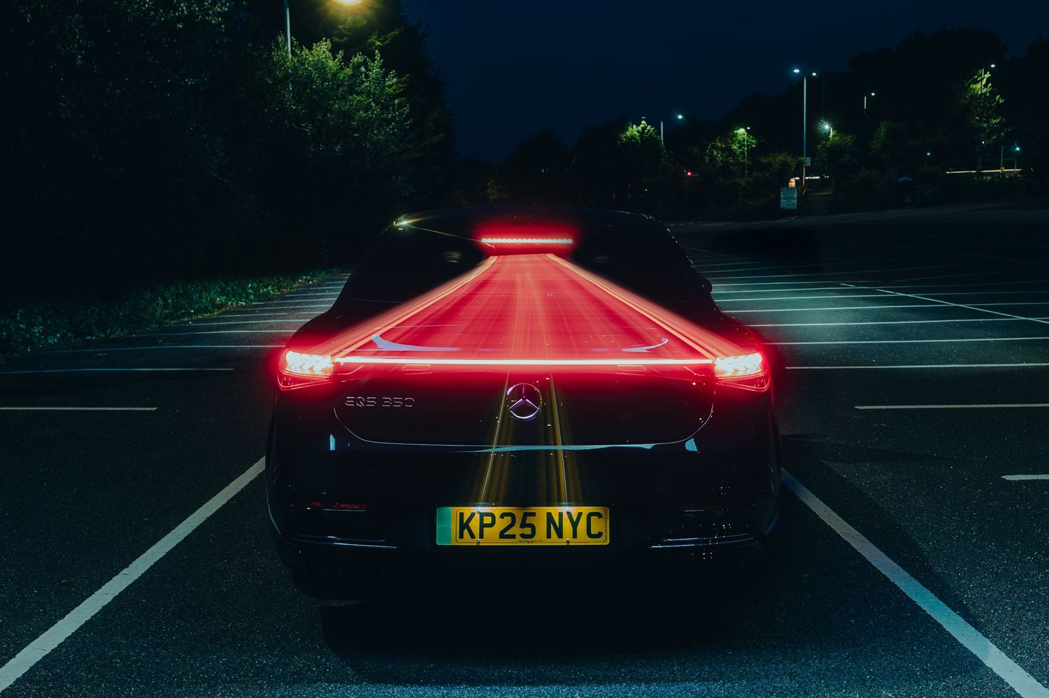 A BYD Dolphin Surf headlights illuminate a dark cobblestone street at night, creating a dramatic scene.