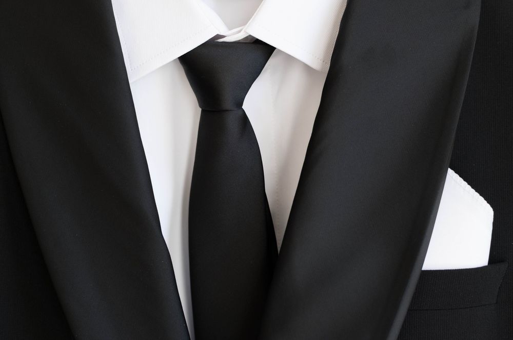 Close-up of a classic black tuxedo with white shirt and black tie.