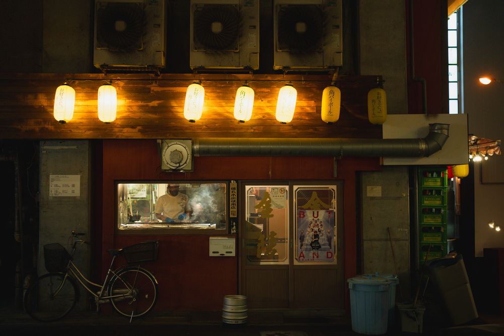 Dimly lit restaurant interior with warm pendant lights hanging from the ceiling.