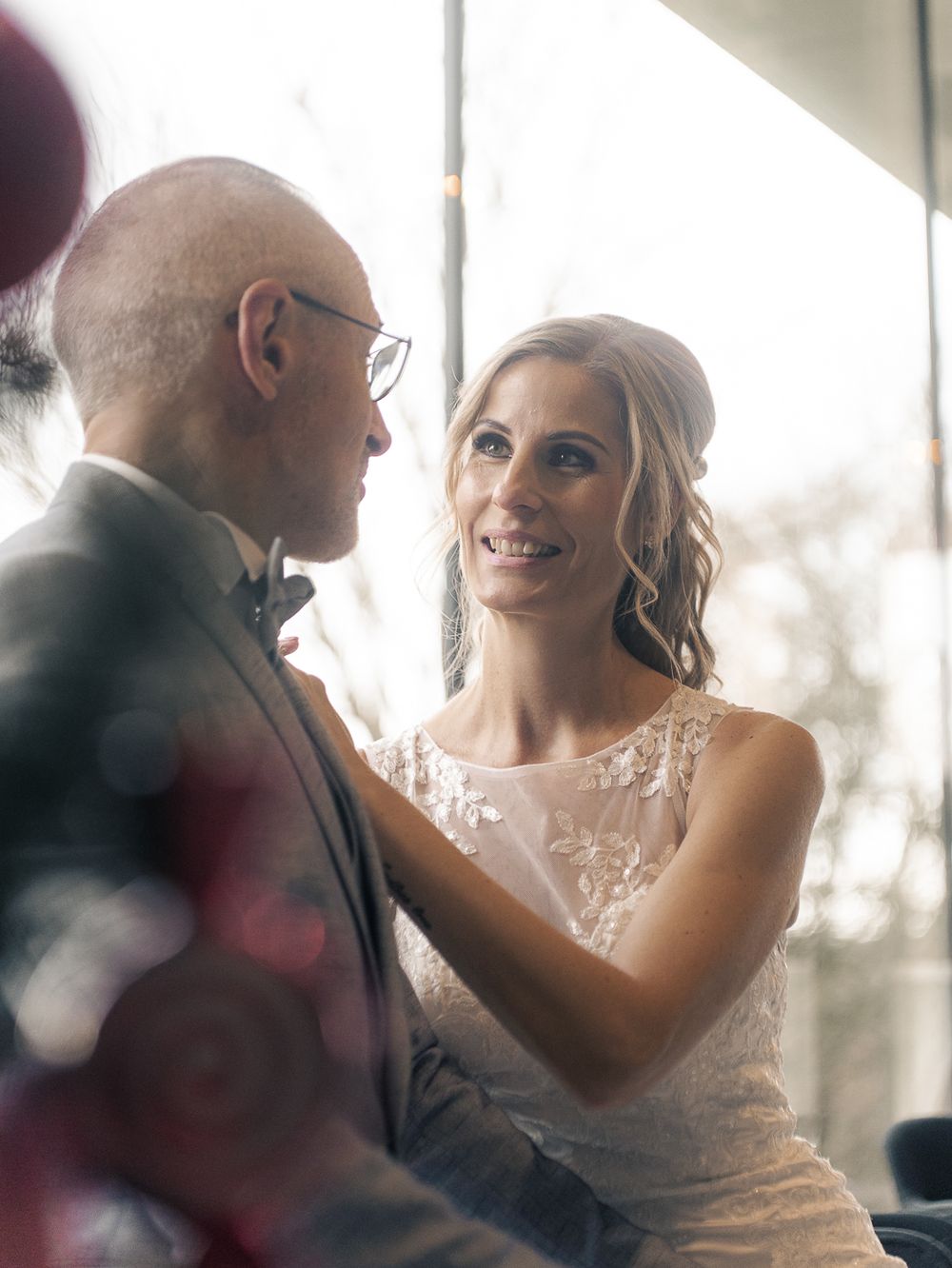 Une scène romantique avec la lumière naturelle qui pénètre par les fenêtres pendant une cérémonie de mariage. Florent Vause