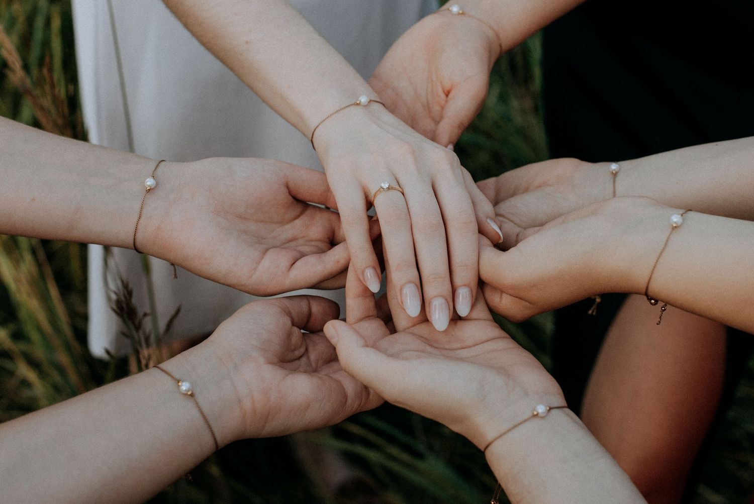 Multiple hands join together in unity showing friendship and connection.