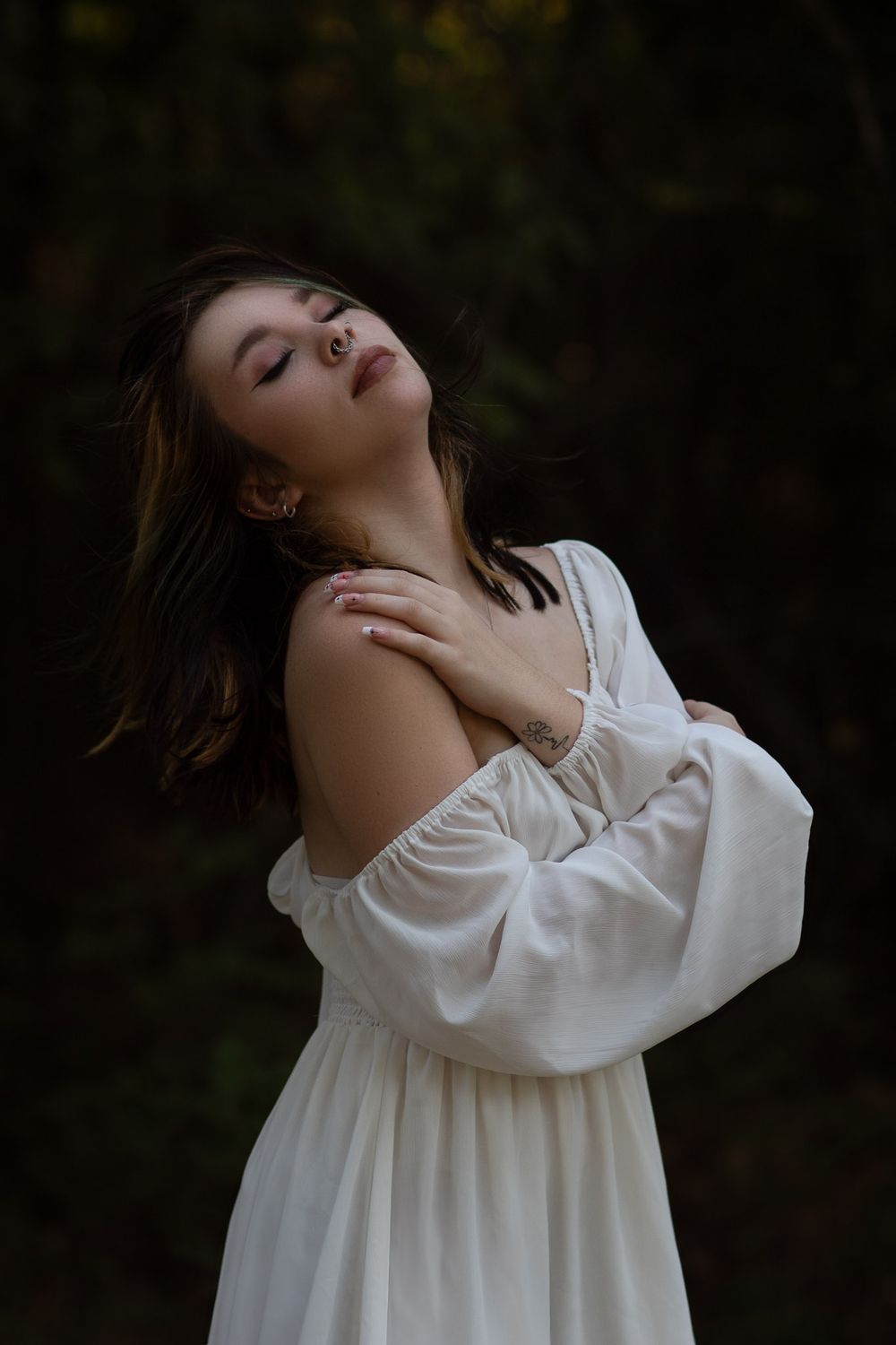 Woman in a flowy white dress during a boudoir photo session in Joplin, Missouri.