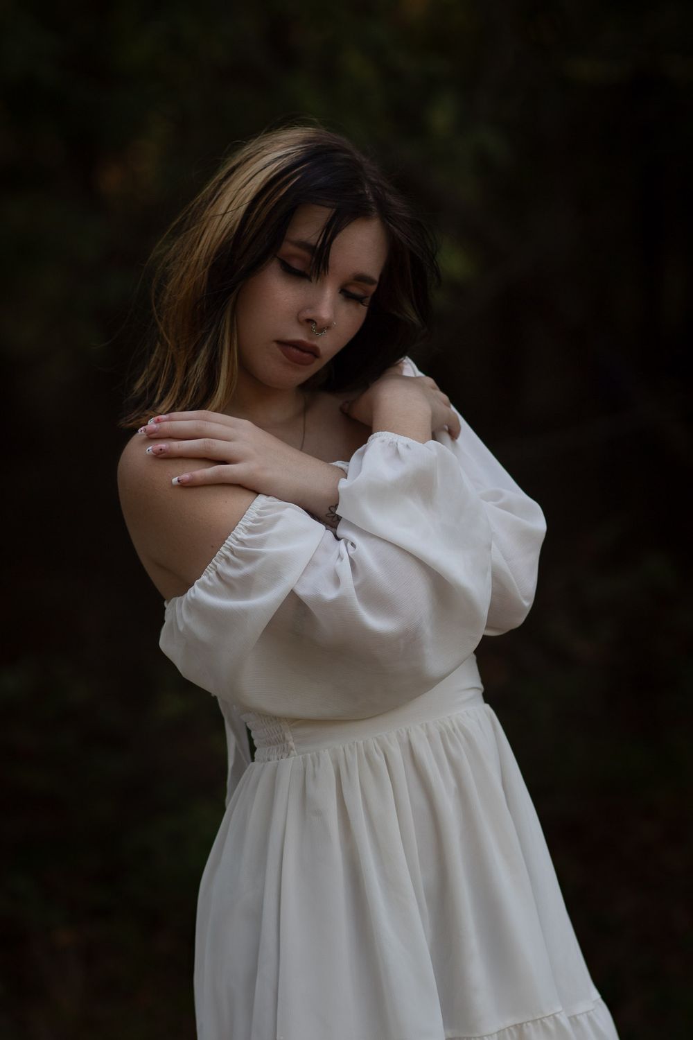 Woman in a flowy white dress during a boudoir photo session in Joplin, Missouri.