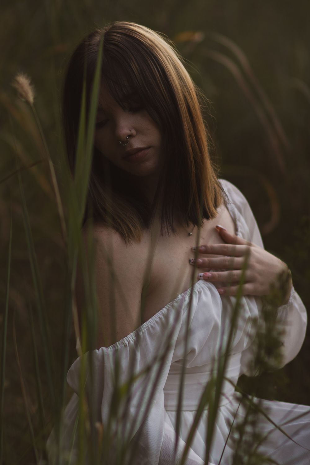 Woman in a flowy white dress during a boudoir photo session in Joplin, Missouri.