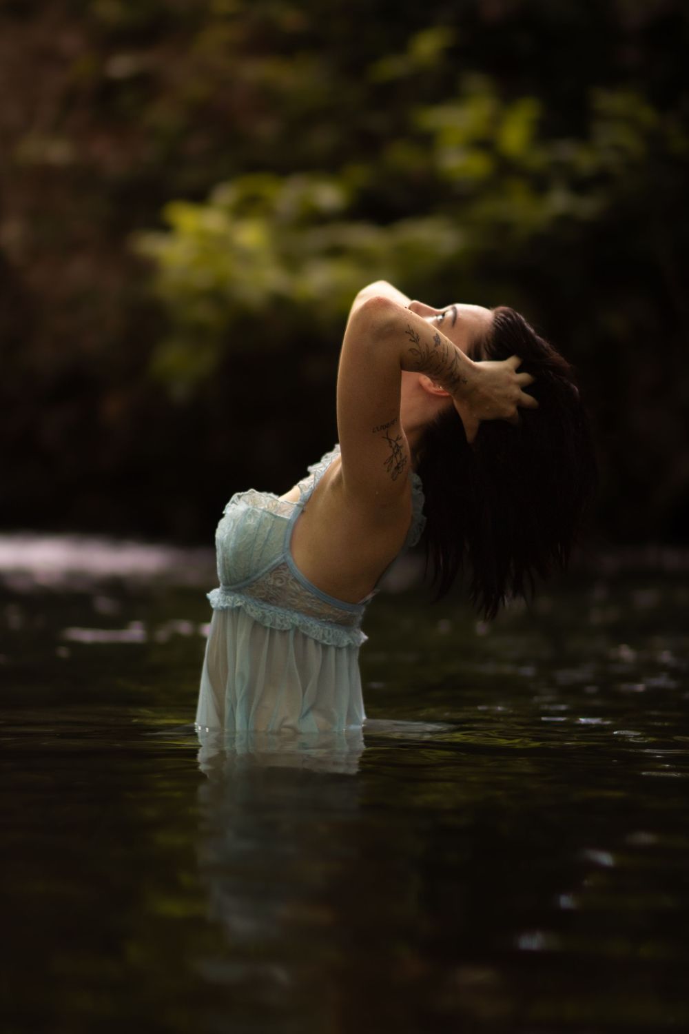 Girl in blue dress in the creek during a boudoir photo session in Joplin, Missouri.