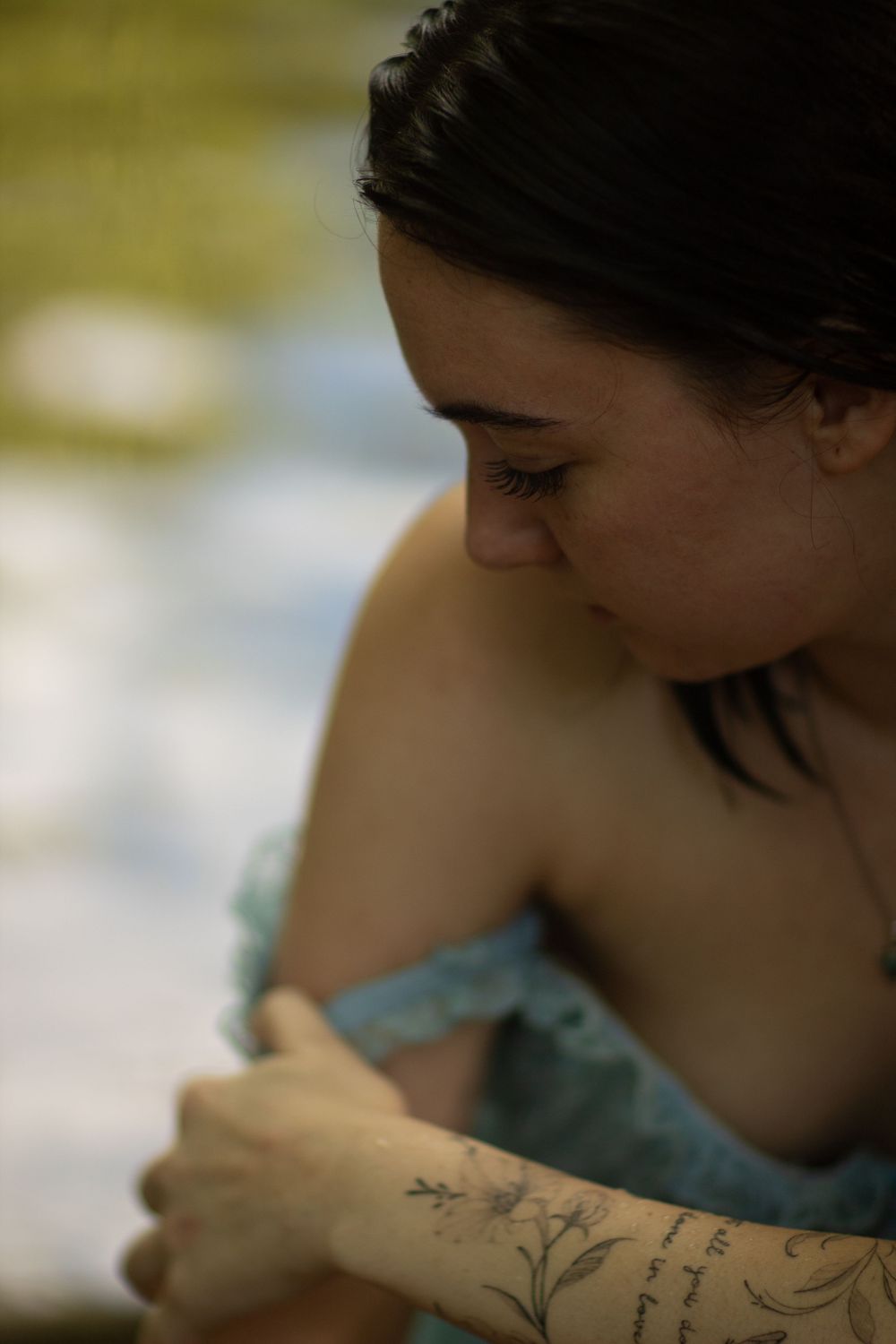 Girl in blue dress in the creek during a boudoir photo session in Joplin, Missouri.