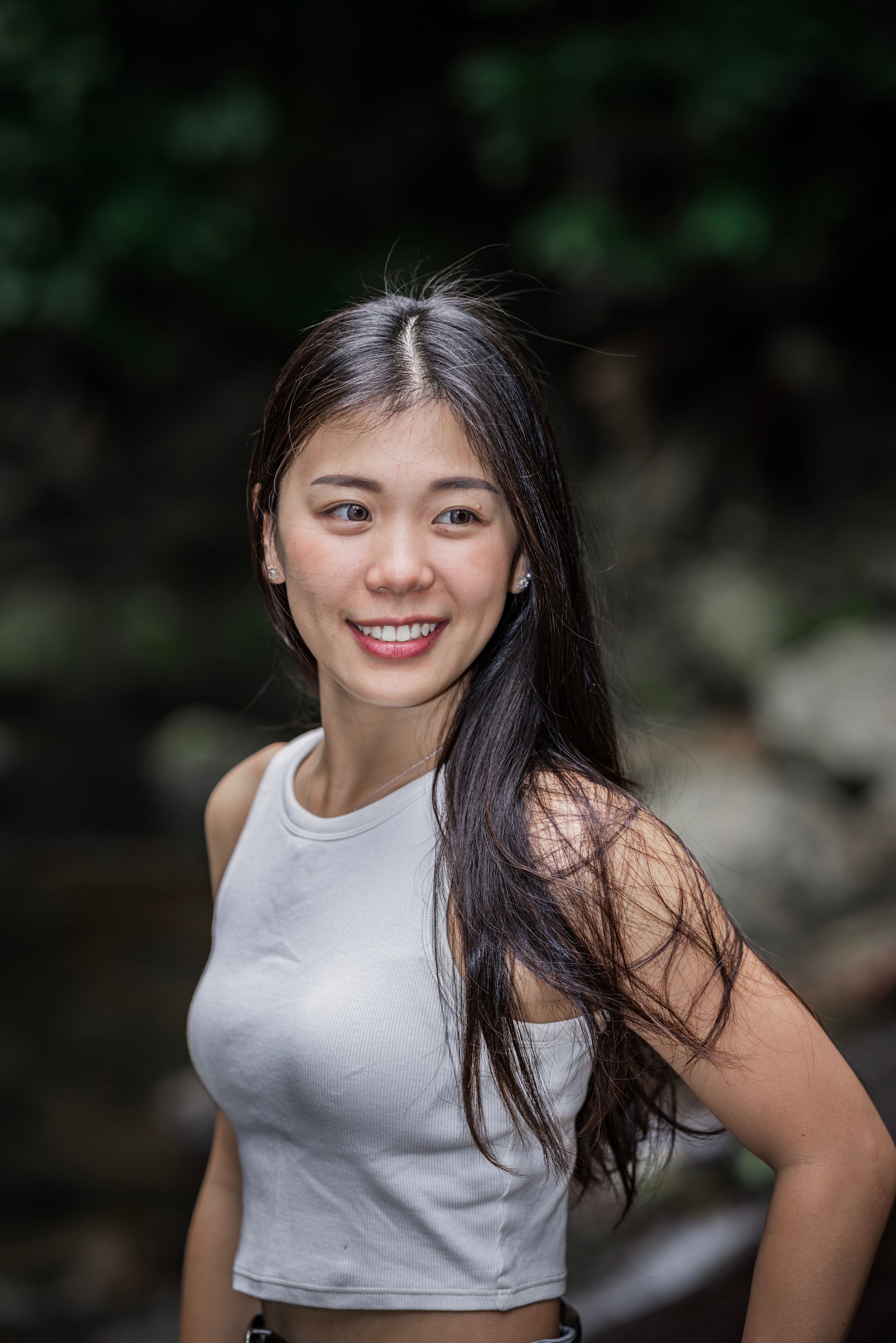 A series of photos of a woman wearing a white sleeveless top set against a blurred natural background.