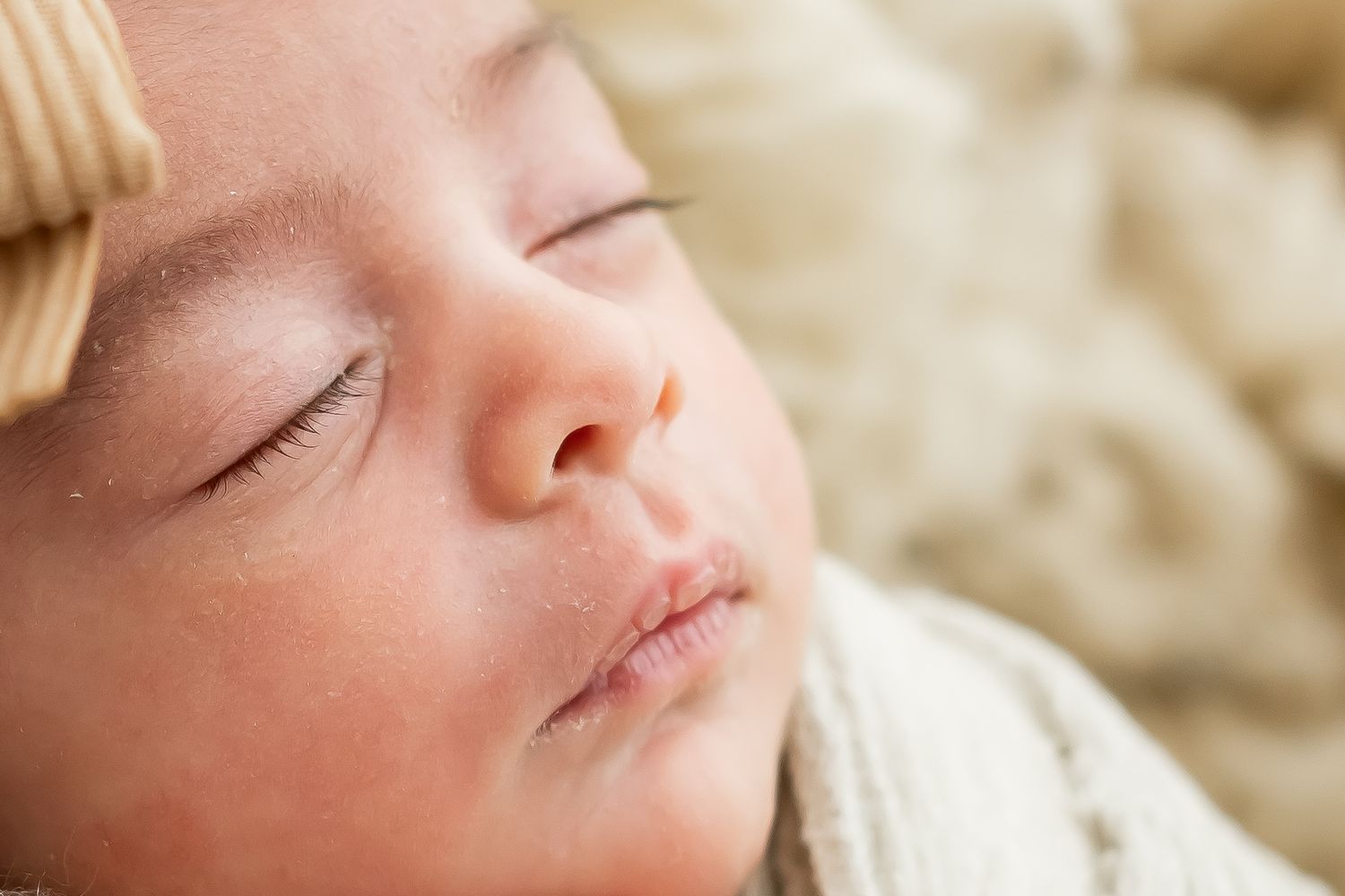 Close up view of a peaceful sleeping baby with soft focus in natural lighting.