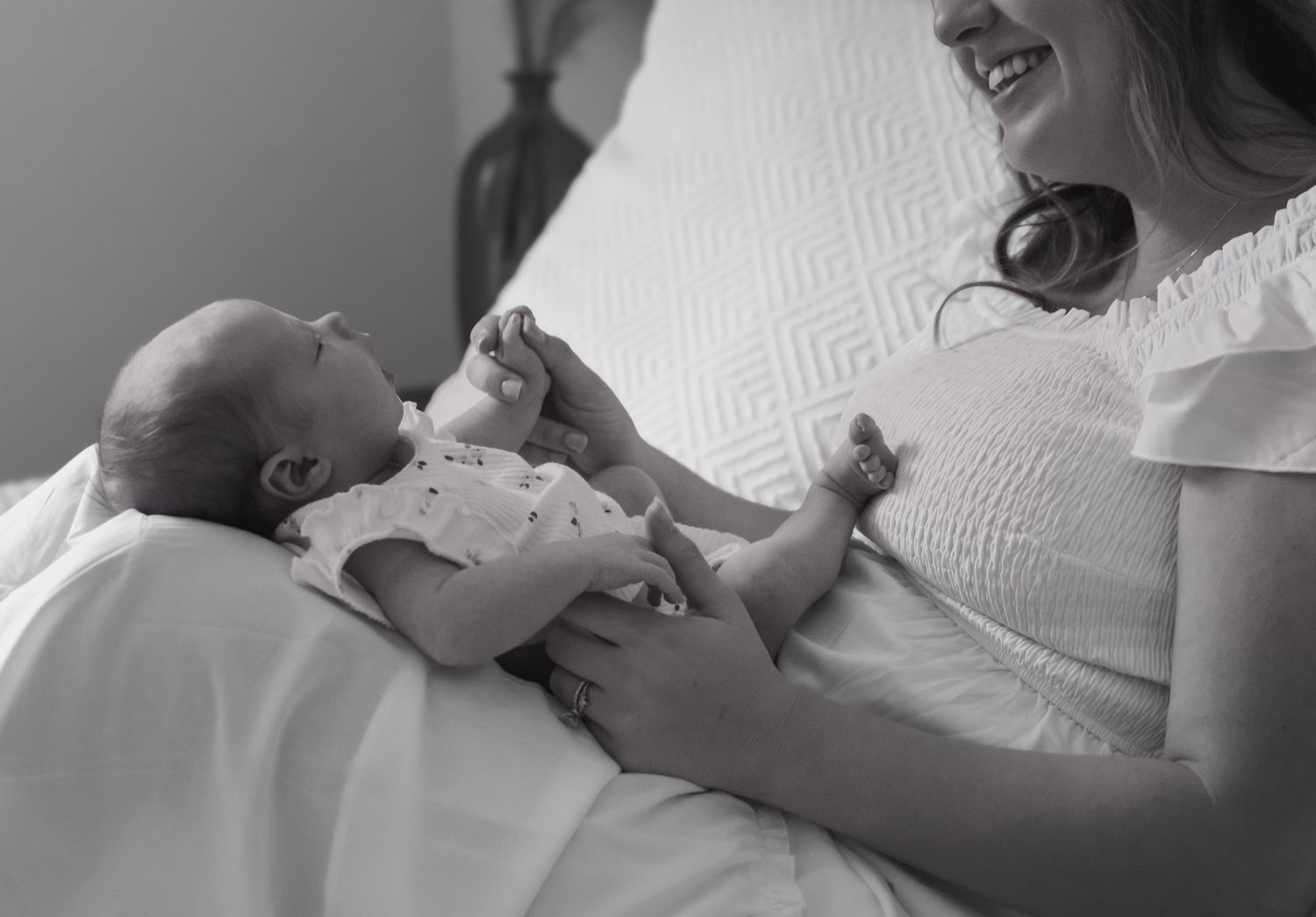 Black and white images of tender moments between parent and baby.