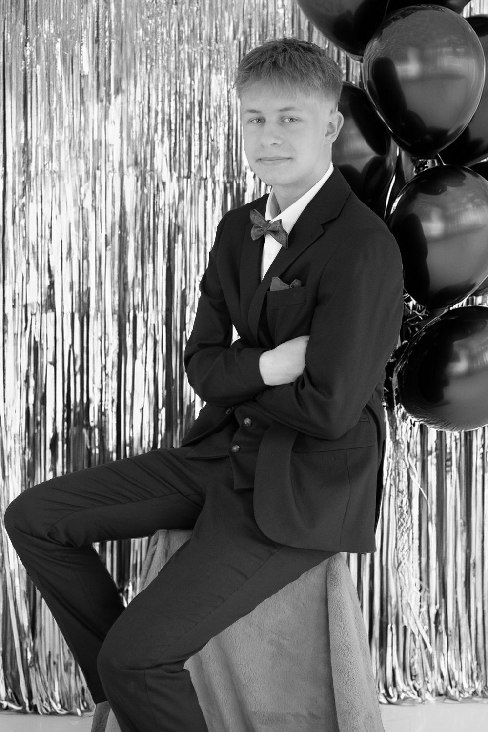 A progressive series of formal portrait poses against a silver tinsel backdrop.