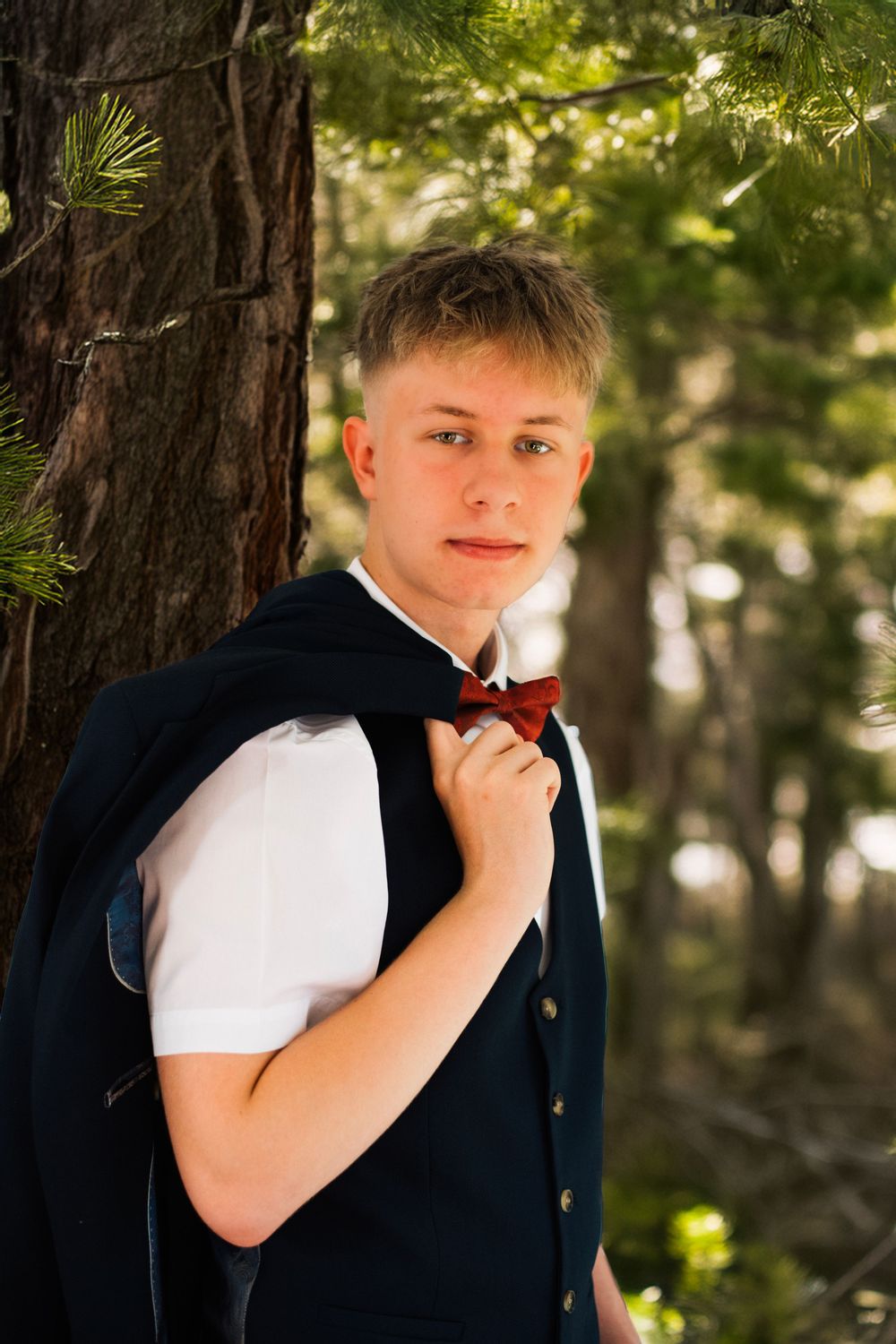 A series of outdoor formal portraits showcasing a bow tie against a natural forest background.