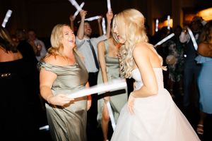 Dancing couple shares a romantic moment during their first dance at an elegant wedding reception celebration.