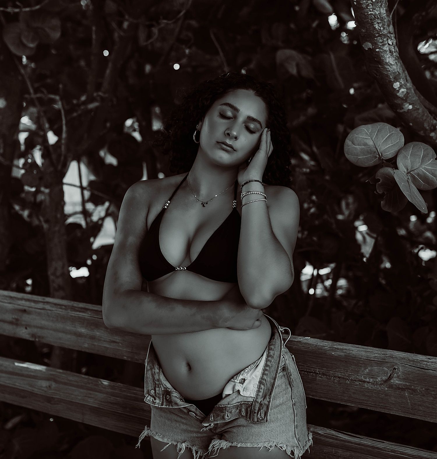 brunette in bikini leaning against fence by Wisconsin boudoir photographer