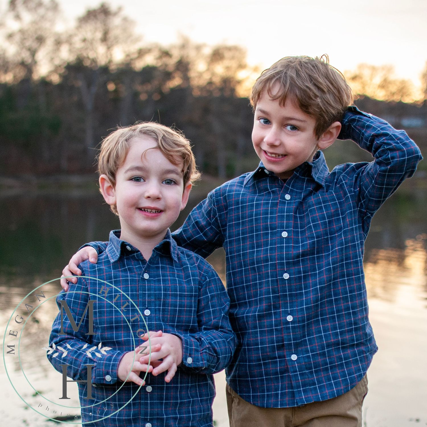 Two young boys together near lake photo