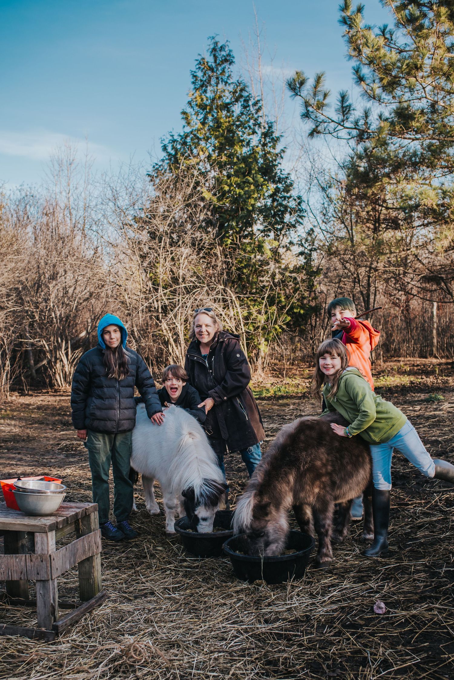 Laurie Lynne of Healing Mini Farm School and a group of children with 2 of her mini horses in the paddock.