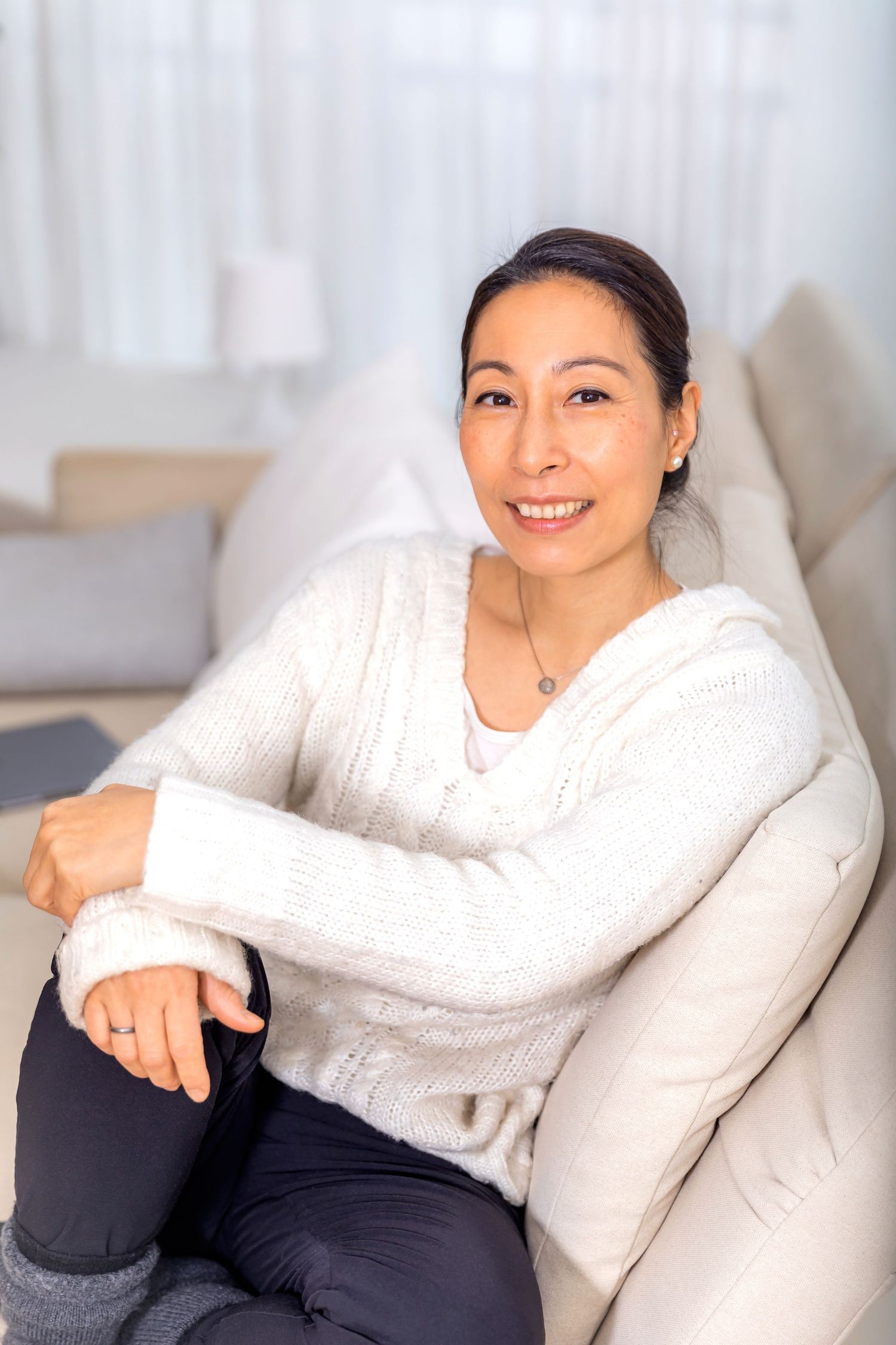 personal branding photoshoot of business woman Berlin working from home on sofa.