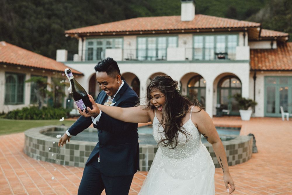 A couple shares candid moments during their wedding photoshoot at a Spanish villa.