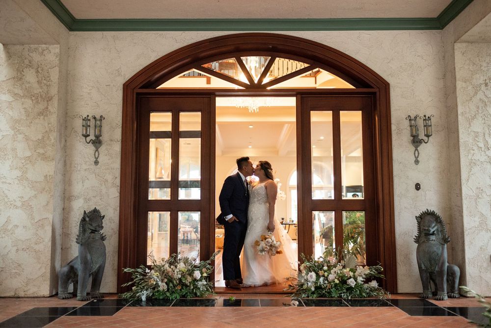 Interior view of an elegant Spanish colonial venue with arched doorways and ornate decor.