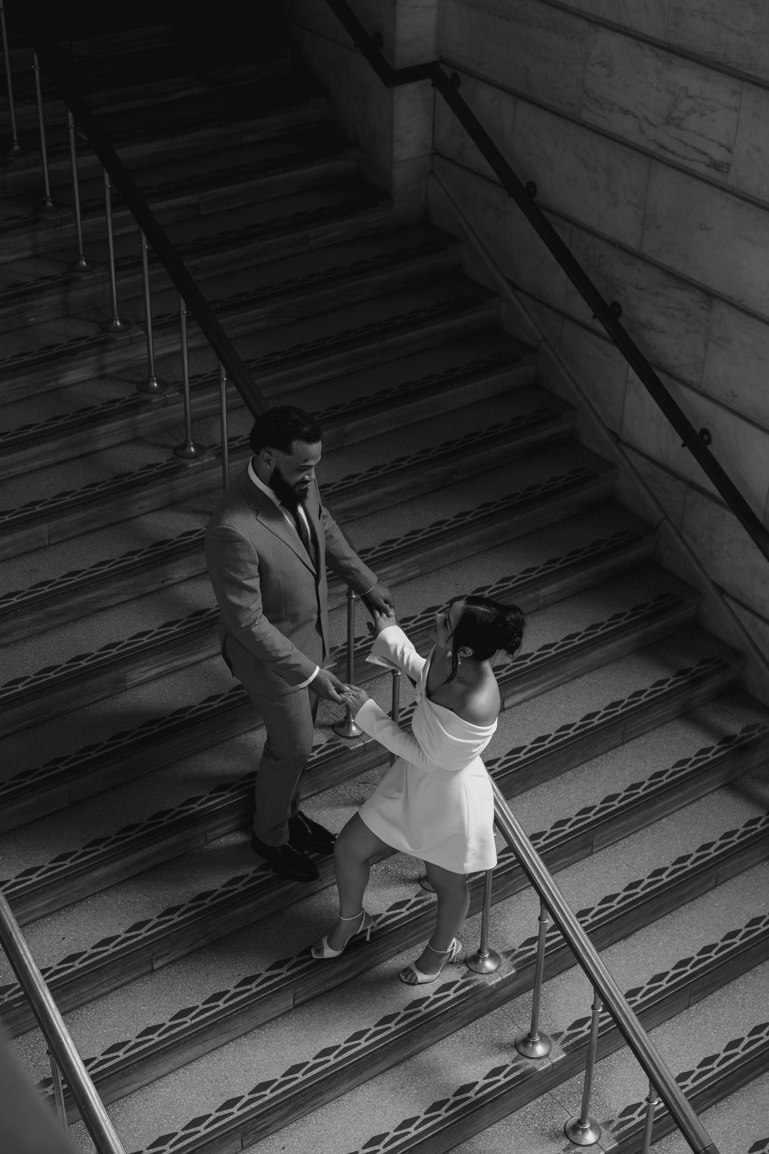 A sequence of black and white photos showing someone climbing up steep wooden stairs in an old building.