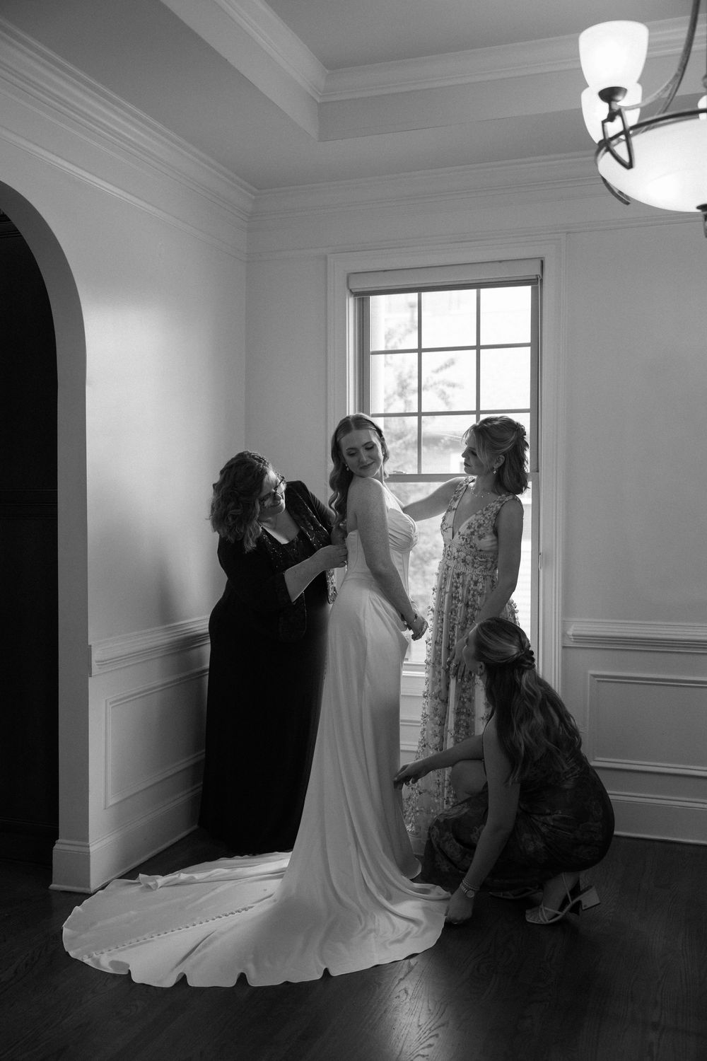 Black and white photo of bride and bridesmaids getting ready for the wedding day at Summerour Studio in Atlanta, Georgia