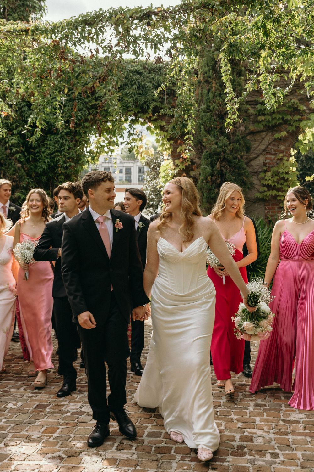 Wedding party walking together candidly for portraits at a Georgia wedding venue