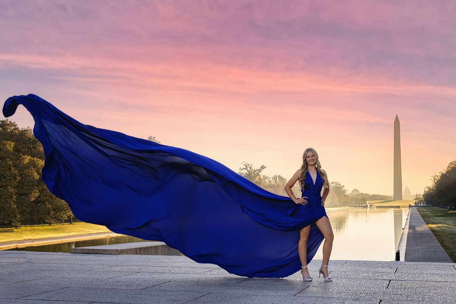 A flowing blue dress billows dramatically against a sunset backdrop with the Washington Monument in the distance. Flying Dress Photos