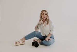 Person in casual denim outfit lounging on white floor in various relaxed poses with minimalist styling.