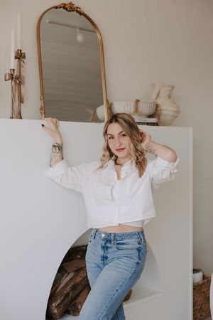Lifestyle portraits showing casual white shirt and jeans outfit poses against mirror.