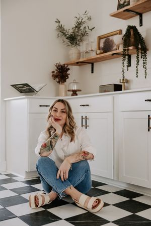 Casual lifestyle photos on a black and white checkered floor with white kitchen cabinets and wooden shelving.